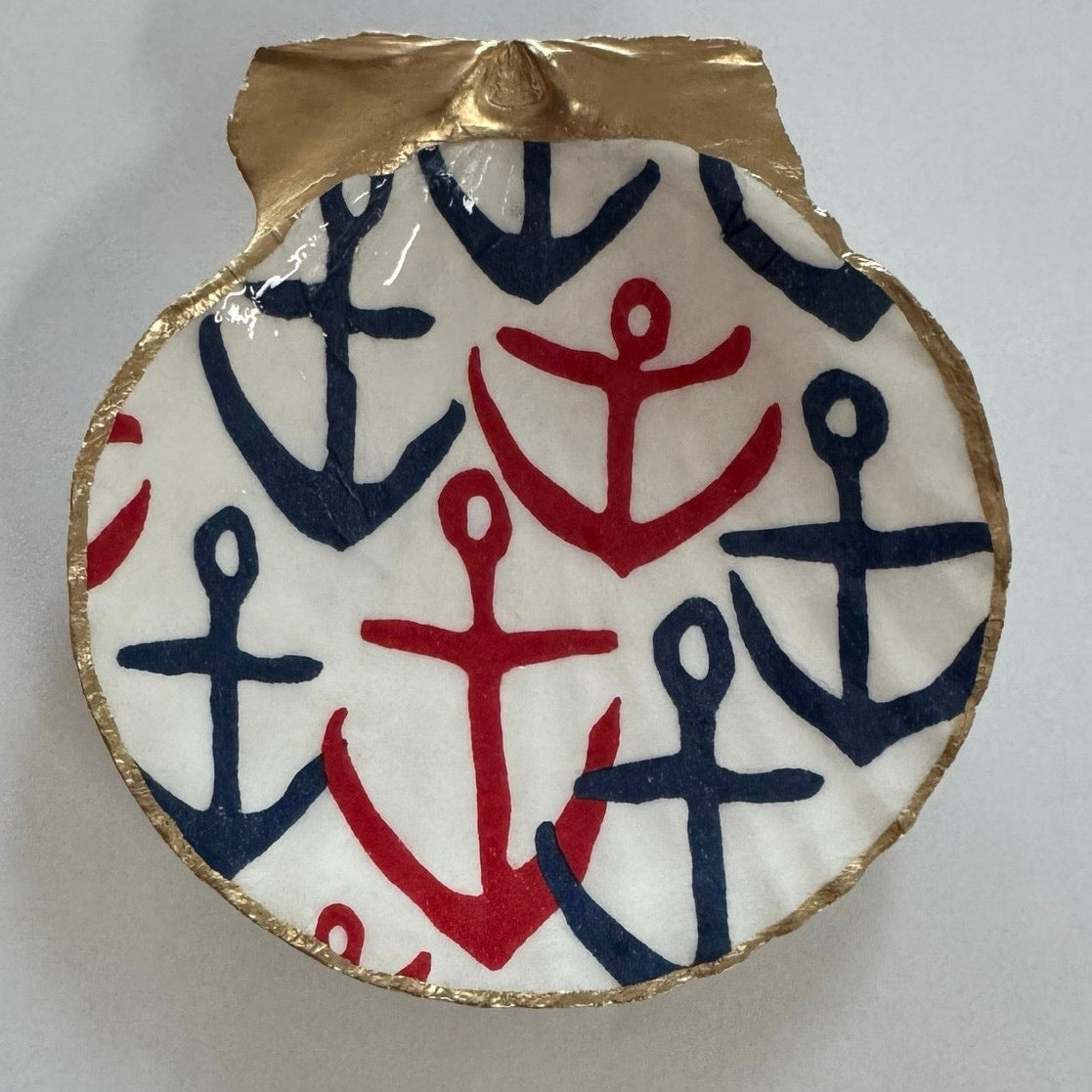 Front view of red and navy anchor trinket dish on a white background